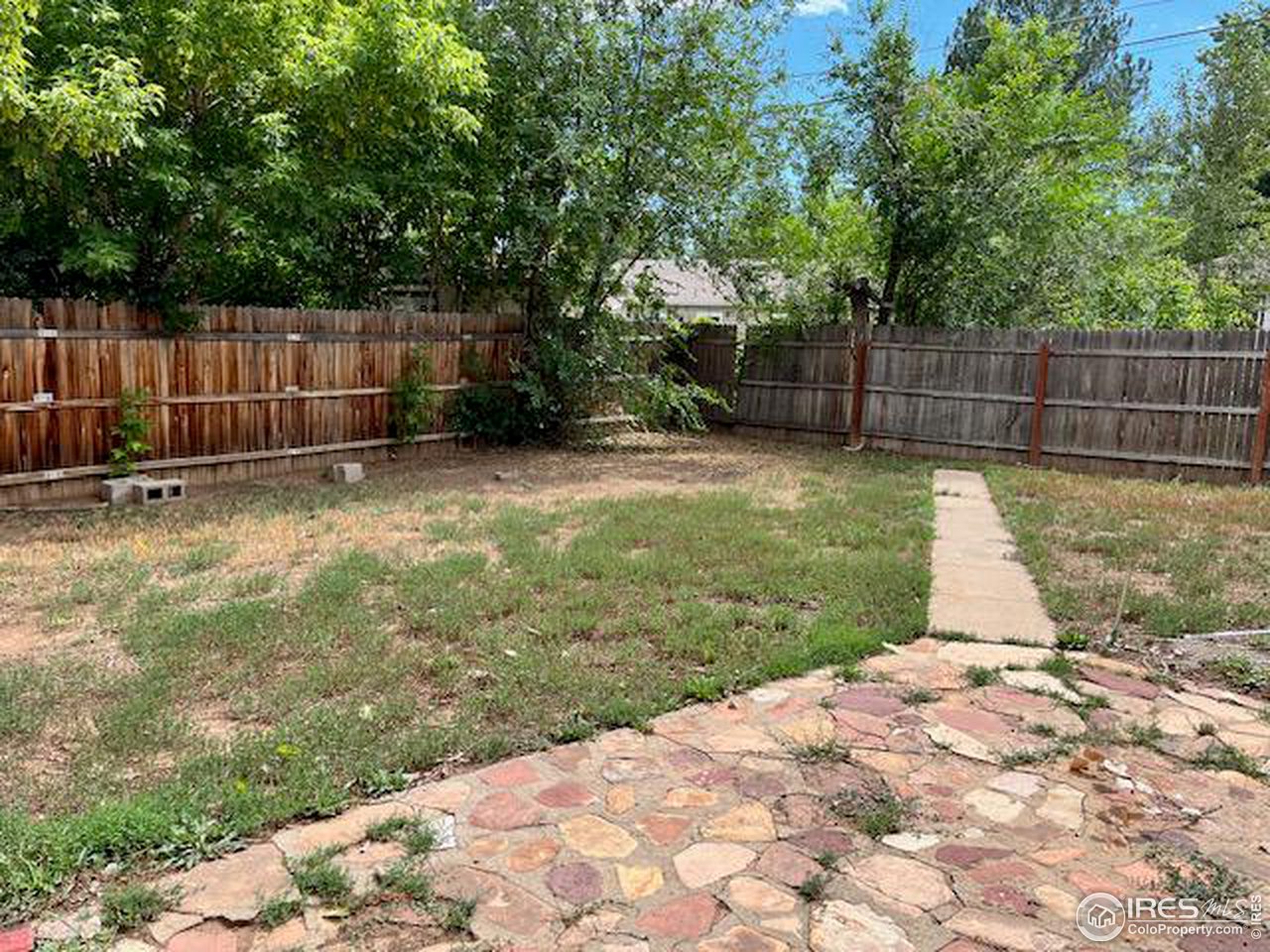 300 27th Street Boulder, CO 80305 - Photo 15 of 21 a view of a backyard with large trees and wooden fence