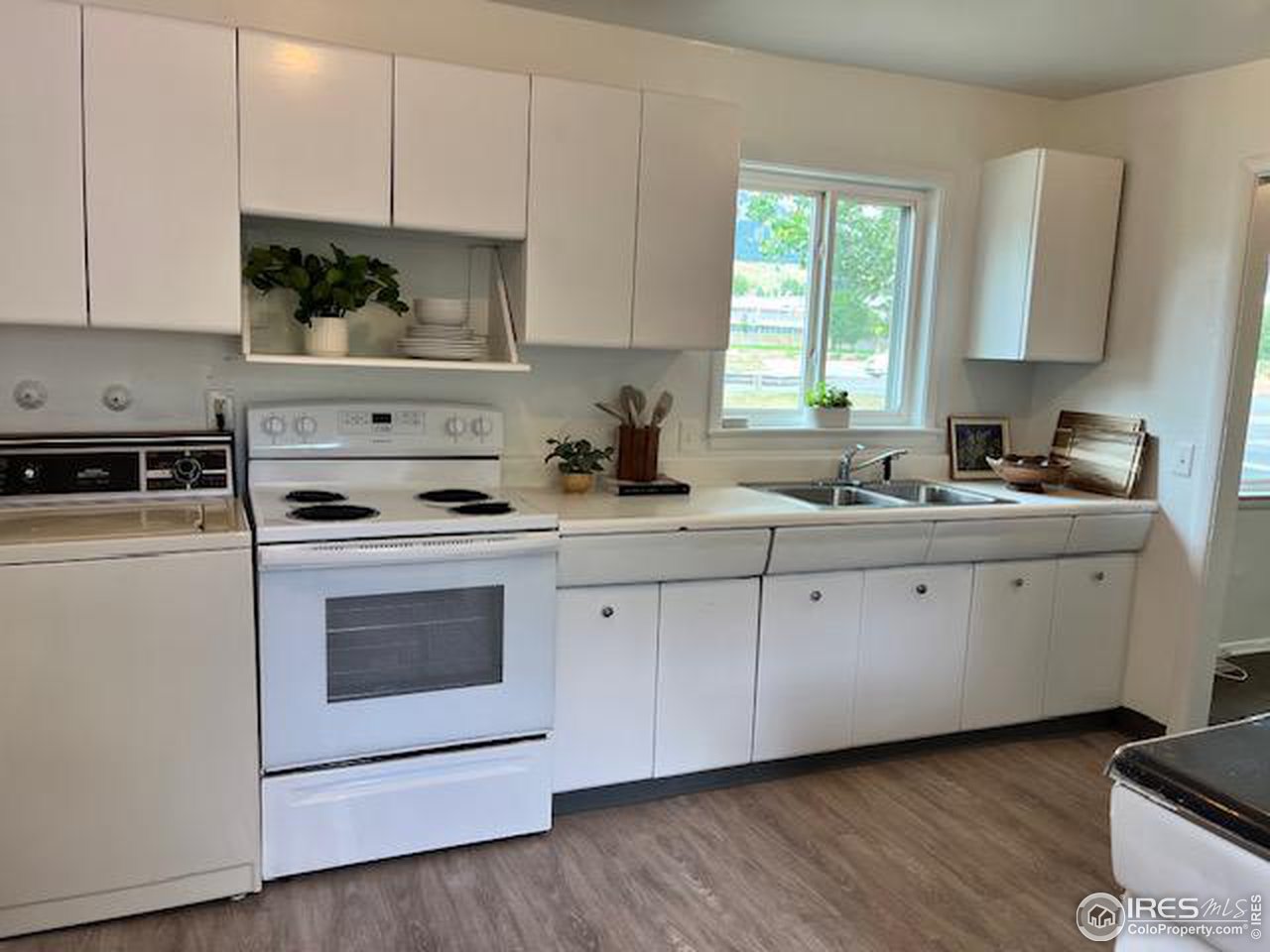 300 27th Street Boulder, CO 80305 - Photo 4 of 21 a kitchen with white cabinets white stainless steel appliances and sink