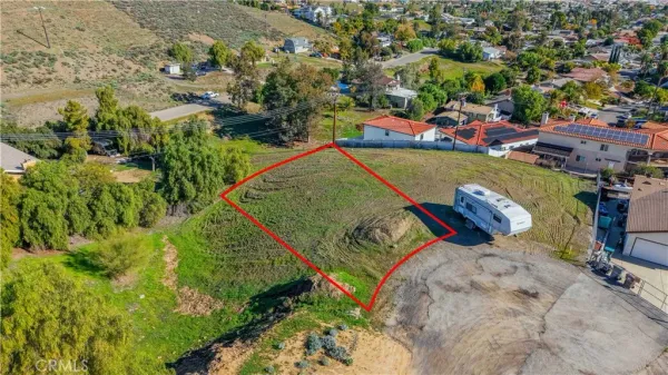 an aerial view of a house with a yard and lake view