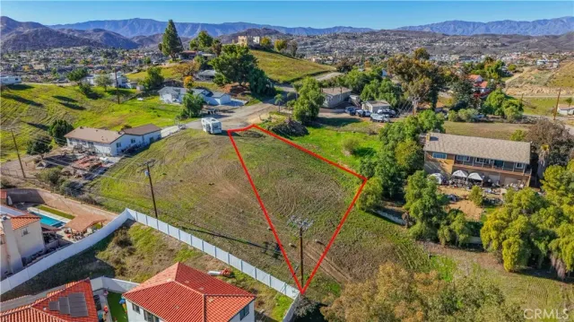 an aerial view of a house with a yard and lake view