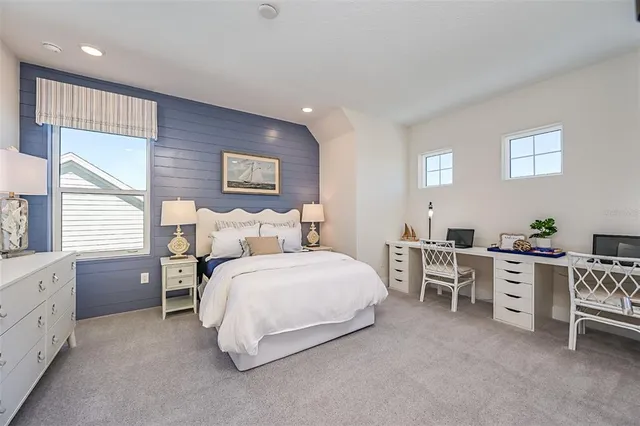 a spacious bedroom with a bed and a table