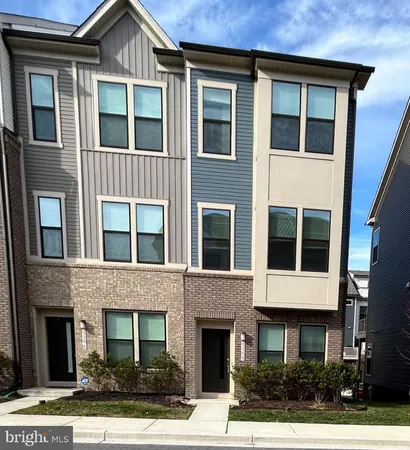a front view of a house with yard and parking space