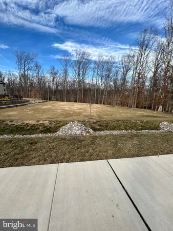 a view of a backyard with sitting area