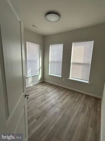 an empty room with windows and closet