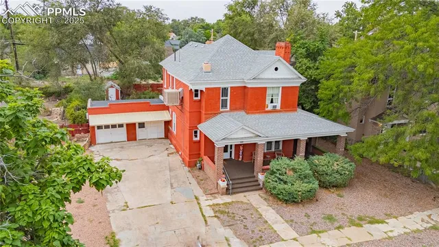 an aerial view of a house with swimming pool and sitting area