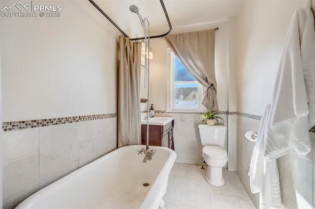 a bathroom with a bathtub a toilet and a shower