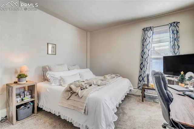 a bedroom with a bed and flat screen tv