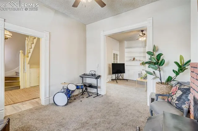 a view of a livingroom with furniture and a potted plant