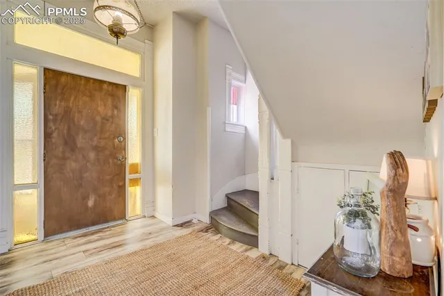 a view of a livingroom with a fireplace and a window