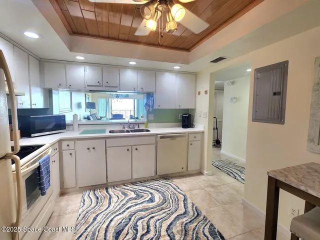a kitchen with a stove a refrigerator and a sink