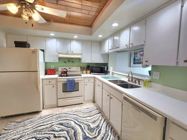 a kitchen with a refrigerator and a sink