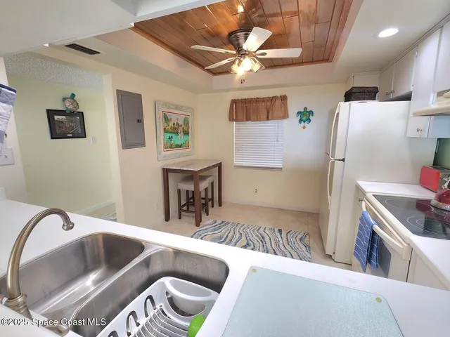 a kitchen with stainless steel appliances granite countertop a sink and a refrigerator