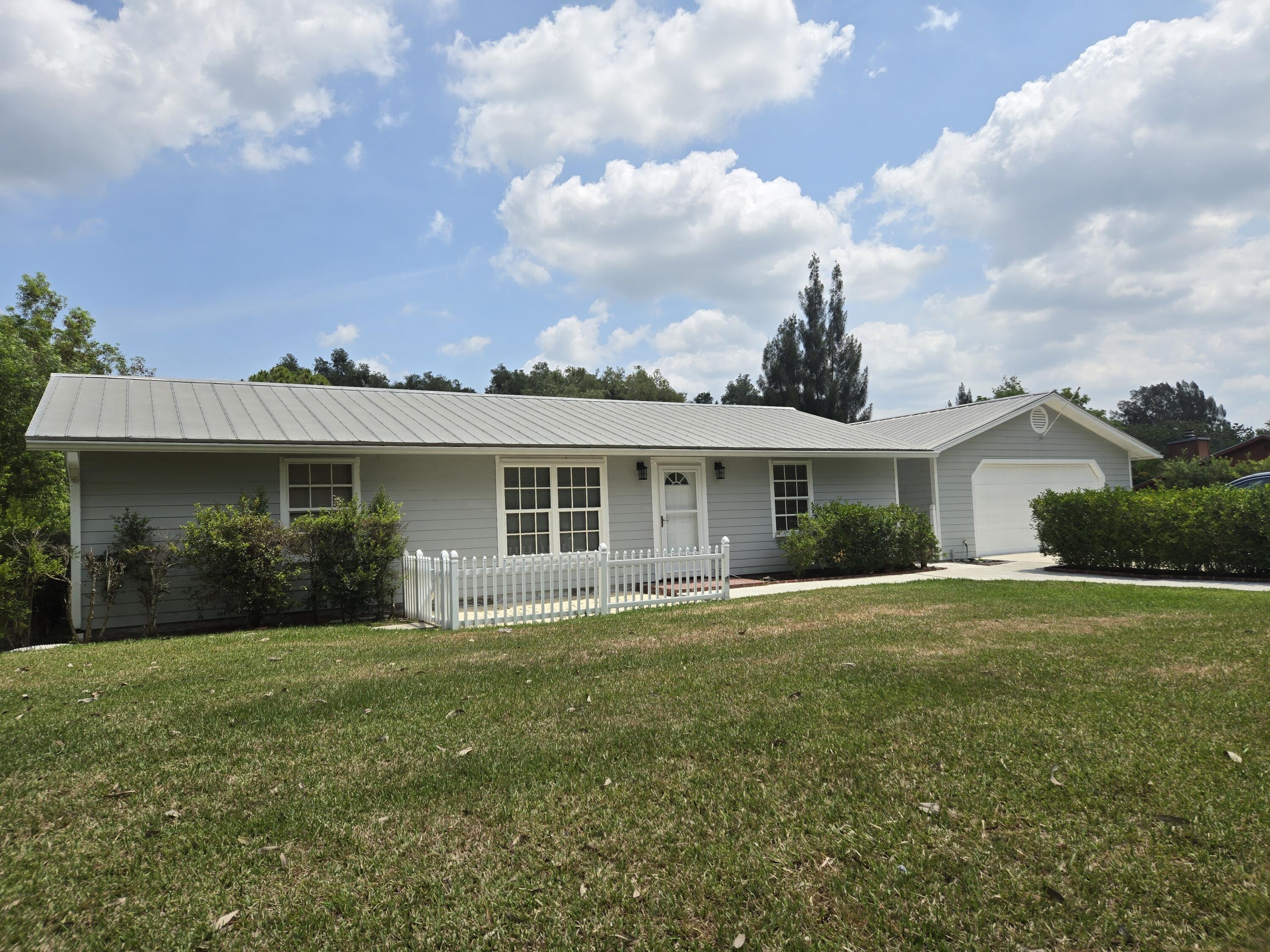 12745 165th Road North Jupiter, FL 33478 - Photo 2 of 13 West side 5-22-24
