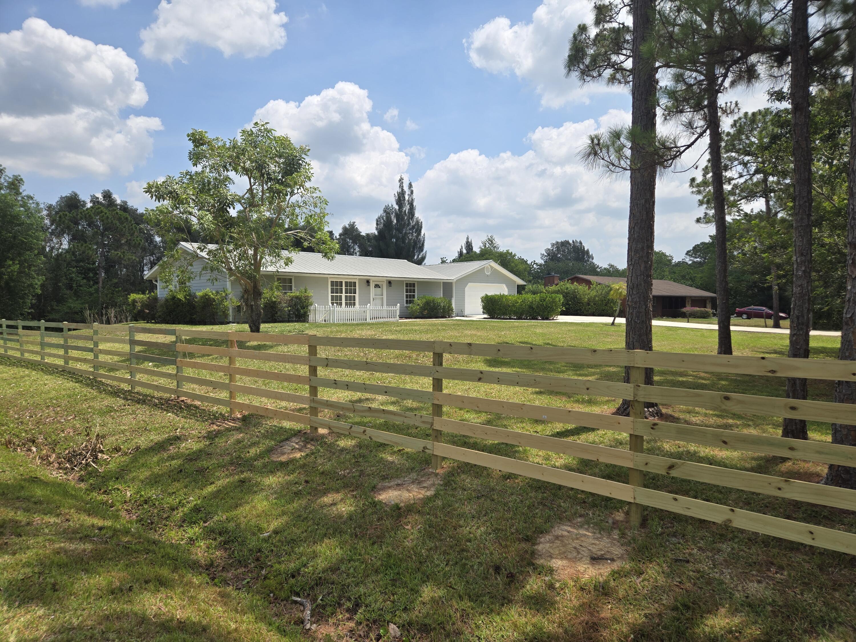 12745 165th Road North Jupiter, FL 33478 - Photo 3 of 13 West side with fence 5-22-24