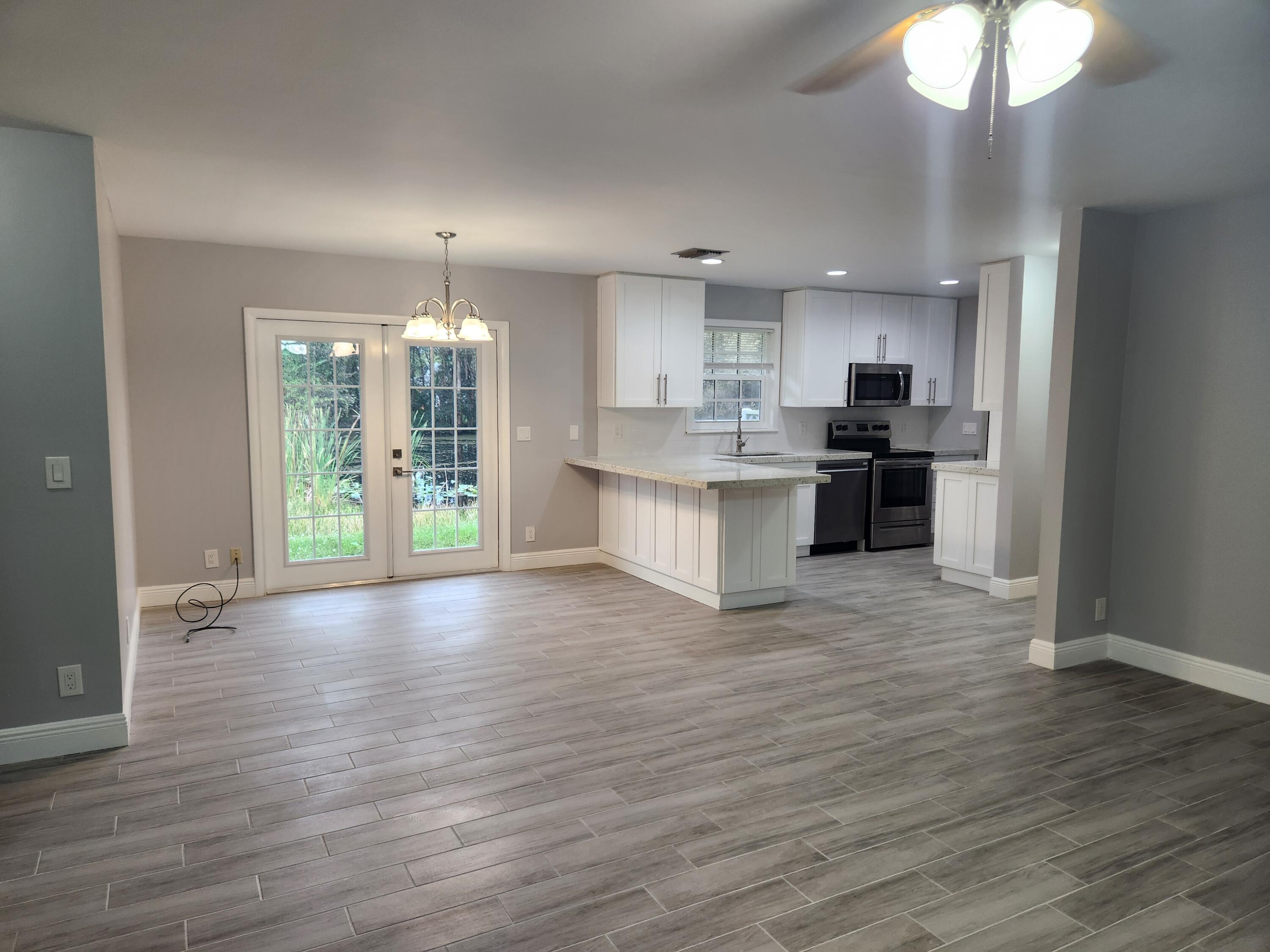 12745 165th Road North Jupiter, FL 33478 - Photo 6 of 13 Living room and Kitchen