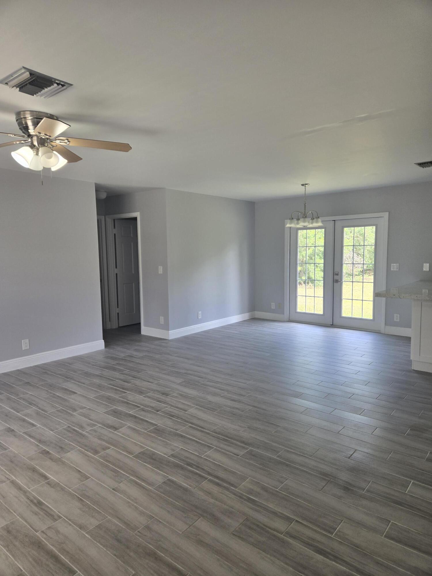 12745 165th Road North Jupiter, FL 33478 - Photo 7 of 13 Living room 5-22-24