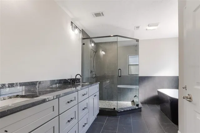 a bathroom with a double vanity sink and mirror