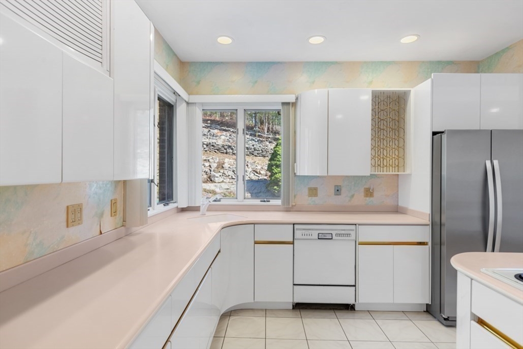 49 Forest Street Saugus, MA 01906 - Photo 11 of 42 a kitchen with a stove a sink and a refrigerator