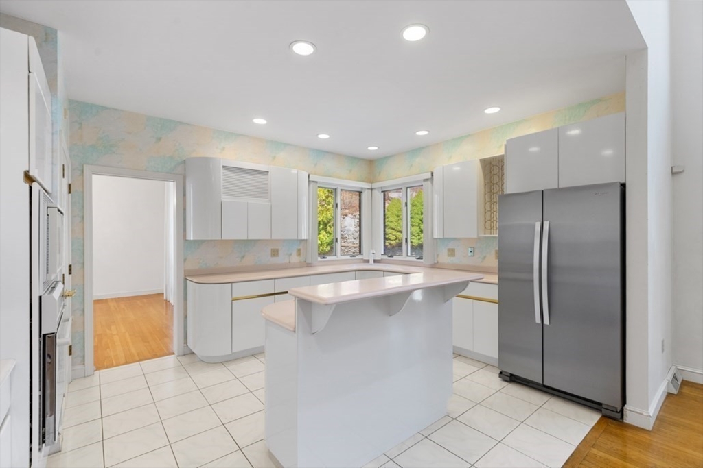 49 Forest Street Saugus, MA 01906 - Photo 12 of 42 a kitchen with stainless steel appliances a refrigerator sink and cabinets