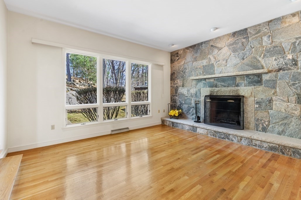 49 Forest Street Saugus, MA 01906 - Photo 17 of 42 a view of an empty room with a fireplace and a window
