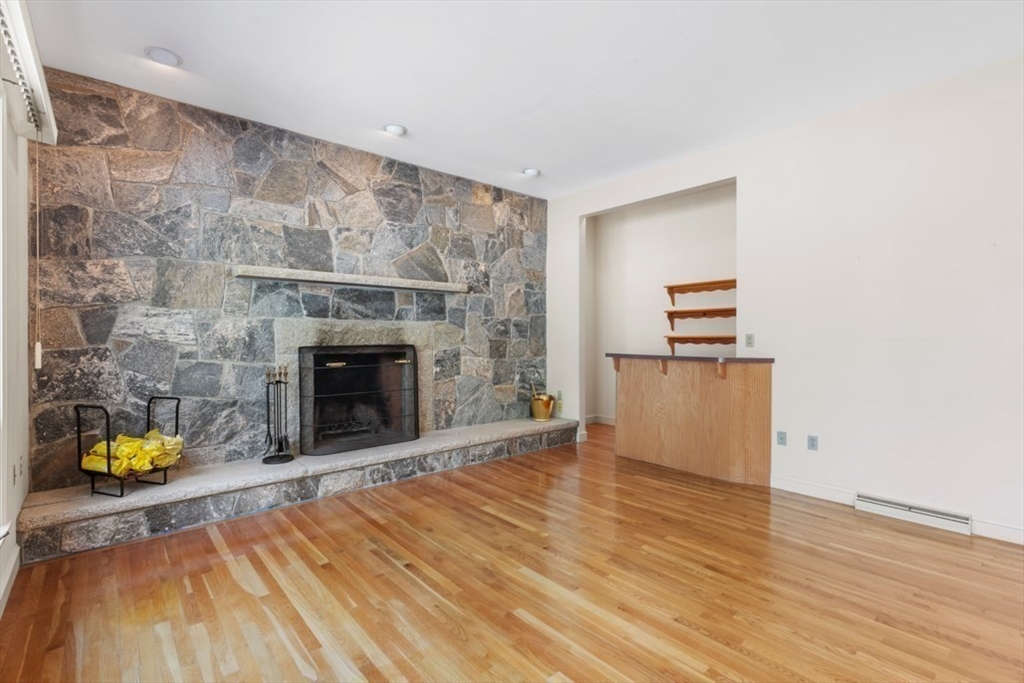 49 Forest Street Saugus, MA 01906 - Photo 18 of 42 a view of empty room with wooden floor and fireplace