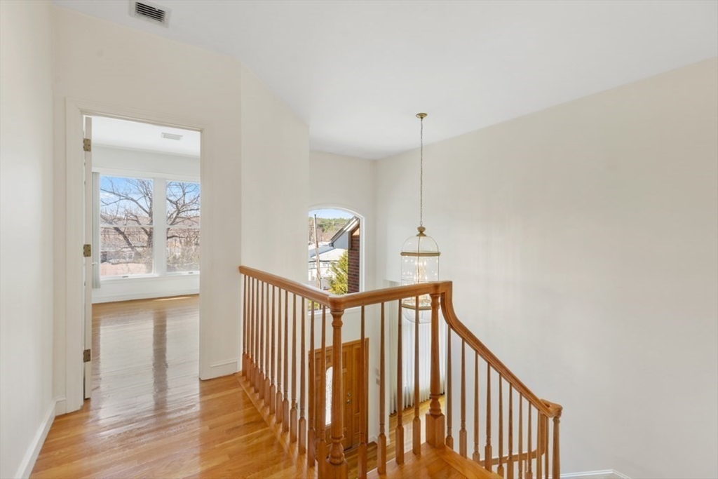 49 Forest Street Saugus, MA 01906 - Photo 24 of 42 a view of a hallway with wooden floor and windows