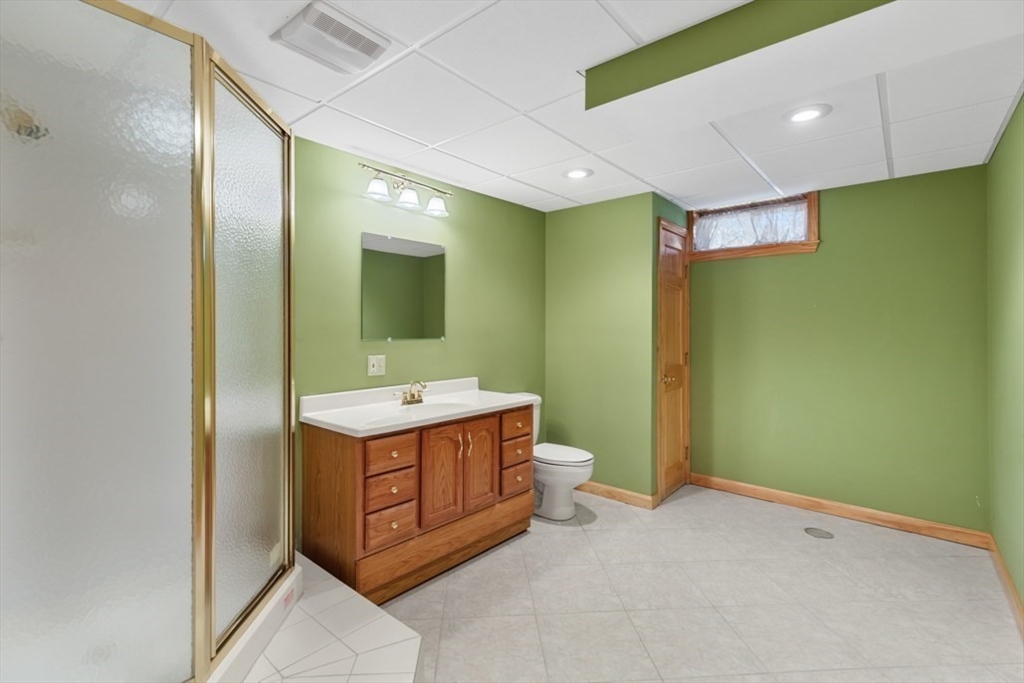 49 Forest Street Saugus, MA 01906 - Photo 35 of 42 a bathroom with a sink a toilet and mirror