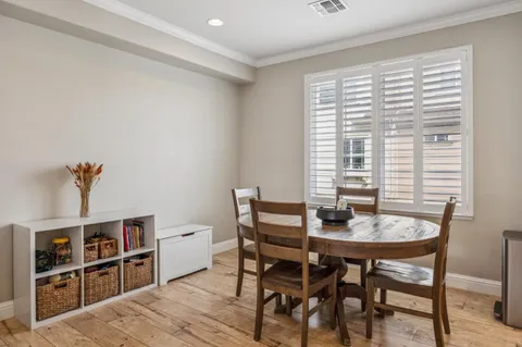 a view of a dining room with furniture and window