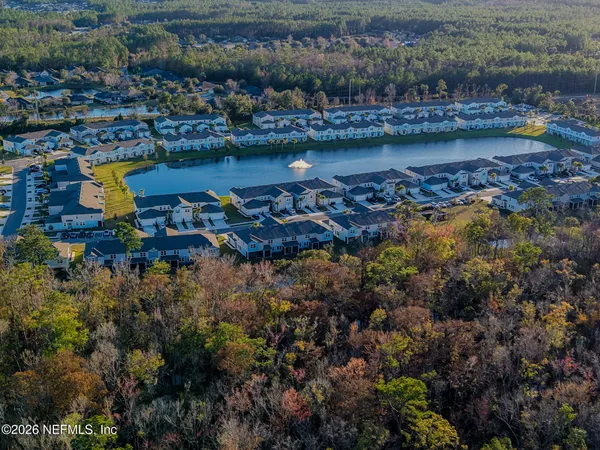 a view of water with boats and trees in the background