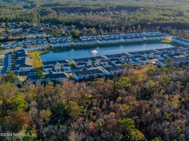 a view of water with boats and trees in the background