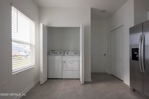 a room with a stove and a refrigerator