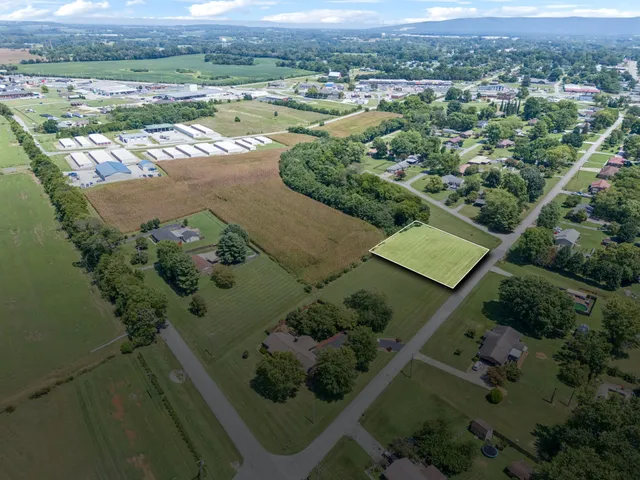 an aerial view of a houses with a yard