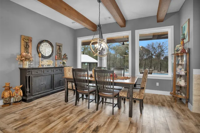 a living room with furniture a rug and a large window