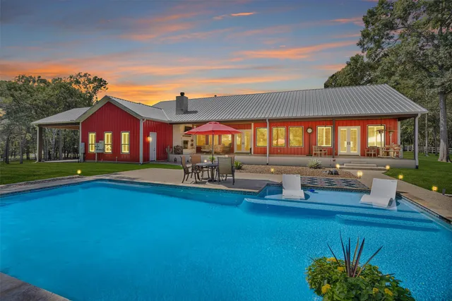 a view of swimming pool with outdoor seating and a yard