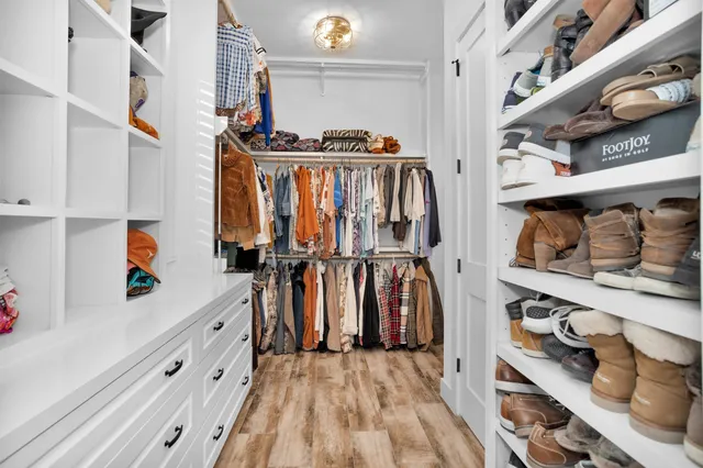 a bedroom with a bed and a chandelier fan