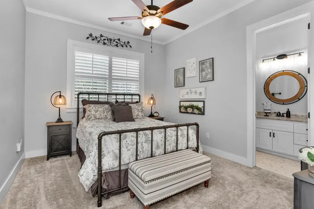 a bathroom with a granite countertop bathtub sink vanity mirror and toilet