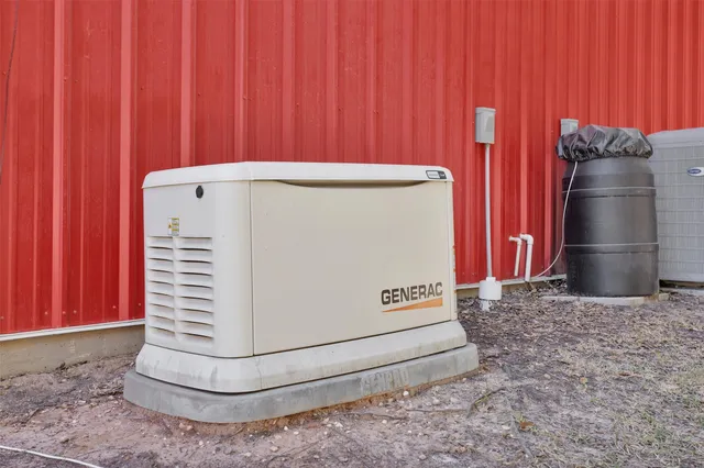 a view of a house with a big yard potted plants and large tree