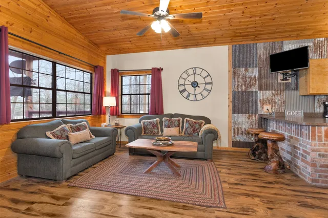 a spacious bedroom with a bed and a flat screen tv