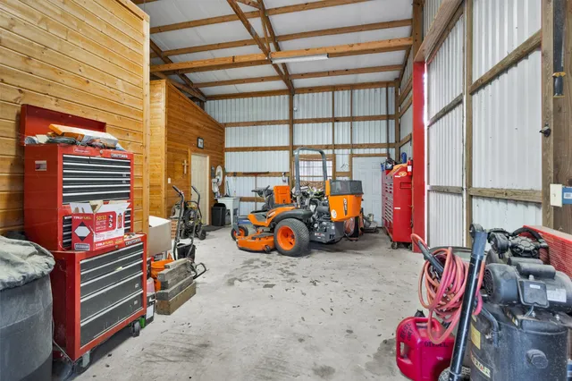 an aerial view of a house with swimming pool and outdoor seating