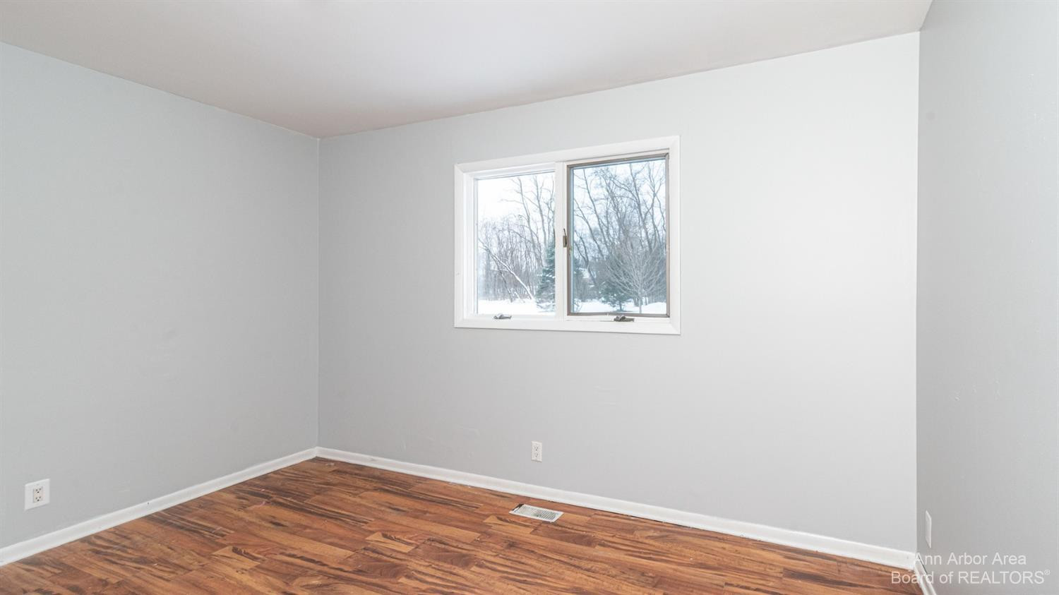 4711 Dexter-Pinckney Road Dexter, MI 48130 - Photo 12 of 30 Primary bedroom with laminate flooring