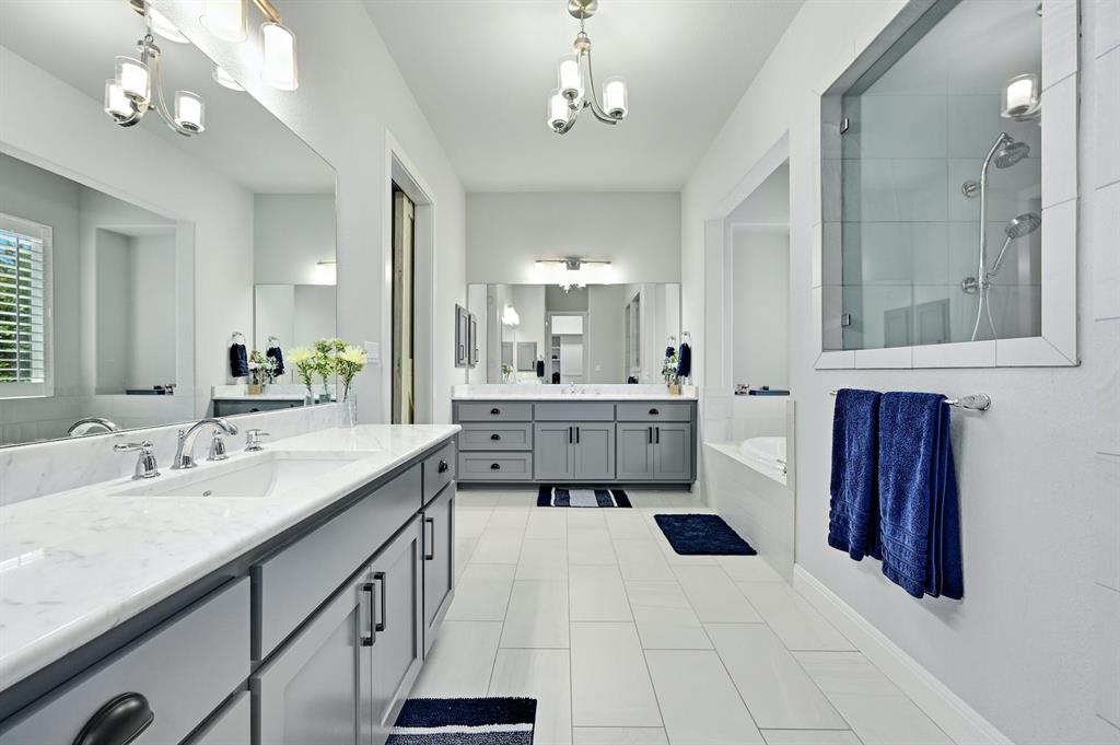 629 Germander Road Leander, TX 78641 - Photo 18 of 38 a bathroom with a sink a vanity a mirror and bathtub