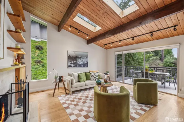 a living room with furniture a fireplace and a flat screen tv