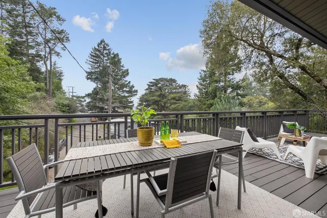 a view of balcony with furniture and wooden deck