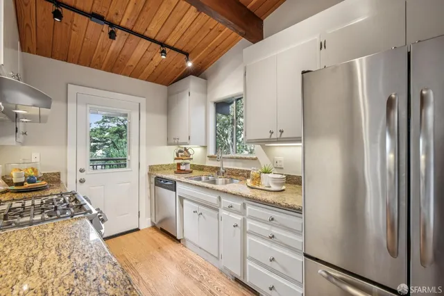 a bedroom with a bed and painting on the wall