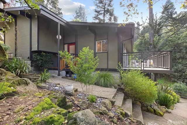 a front view of a house with garden
