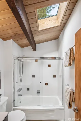 an aerial view of residential houses with city view and green space