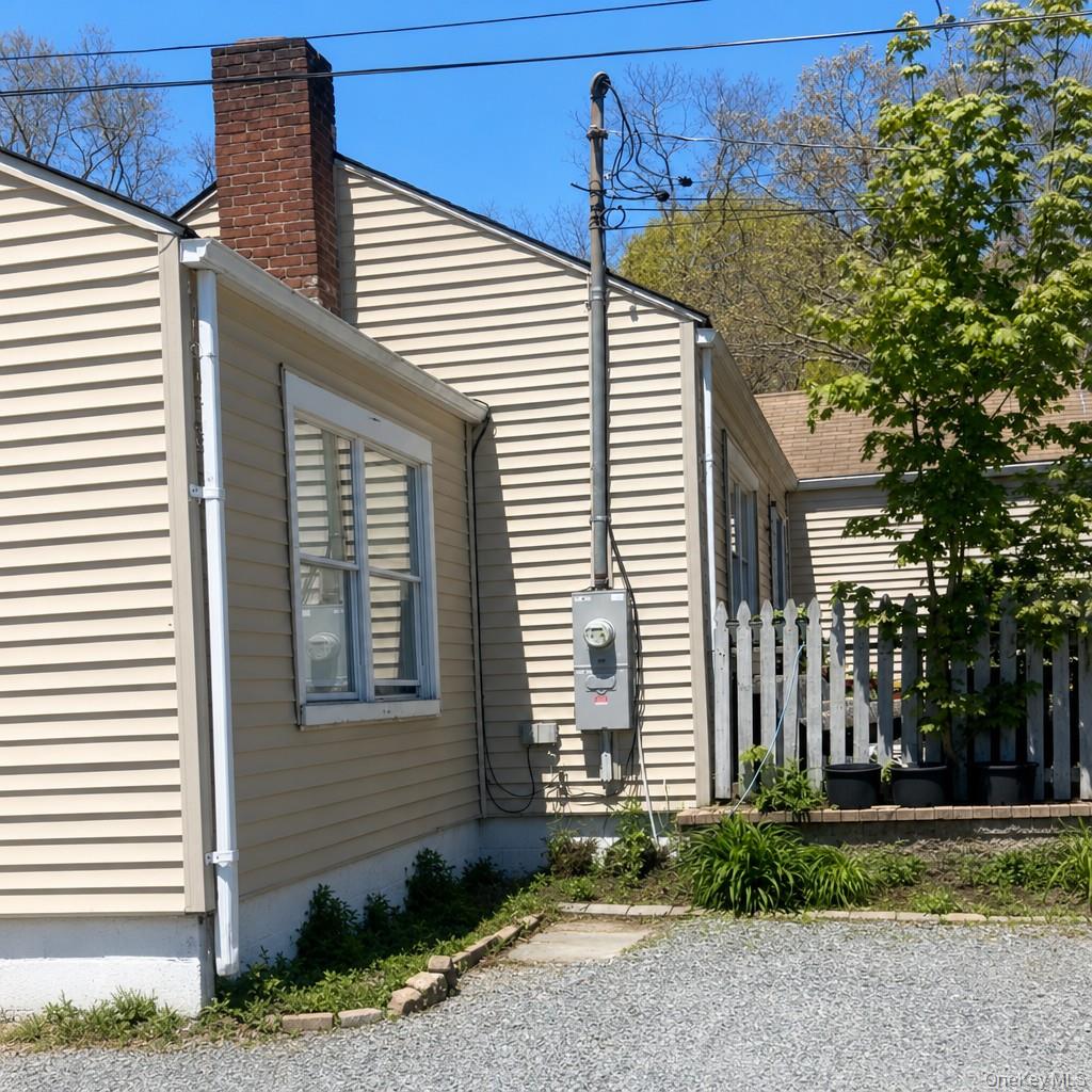 719 North Sea Road Southampton, NY 11968 - Photo 2 of 6 a front view of a house with a yard