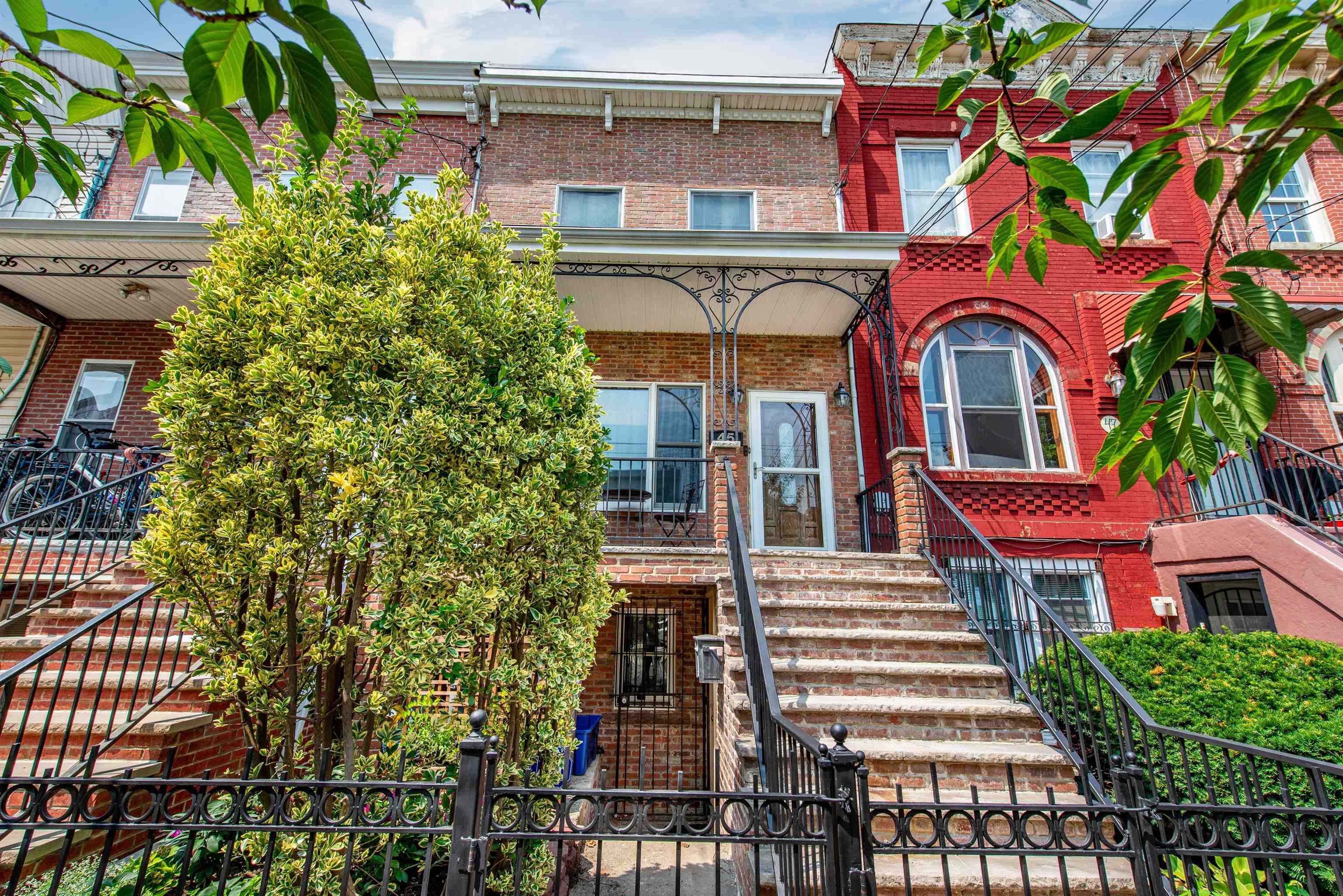 a front view of a multi story residential apartment building with a yard