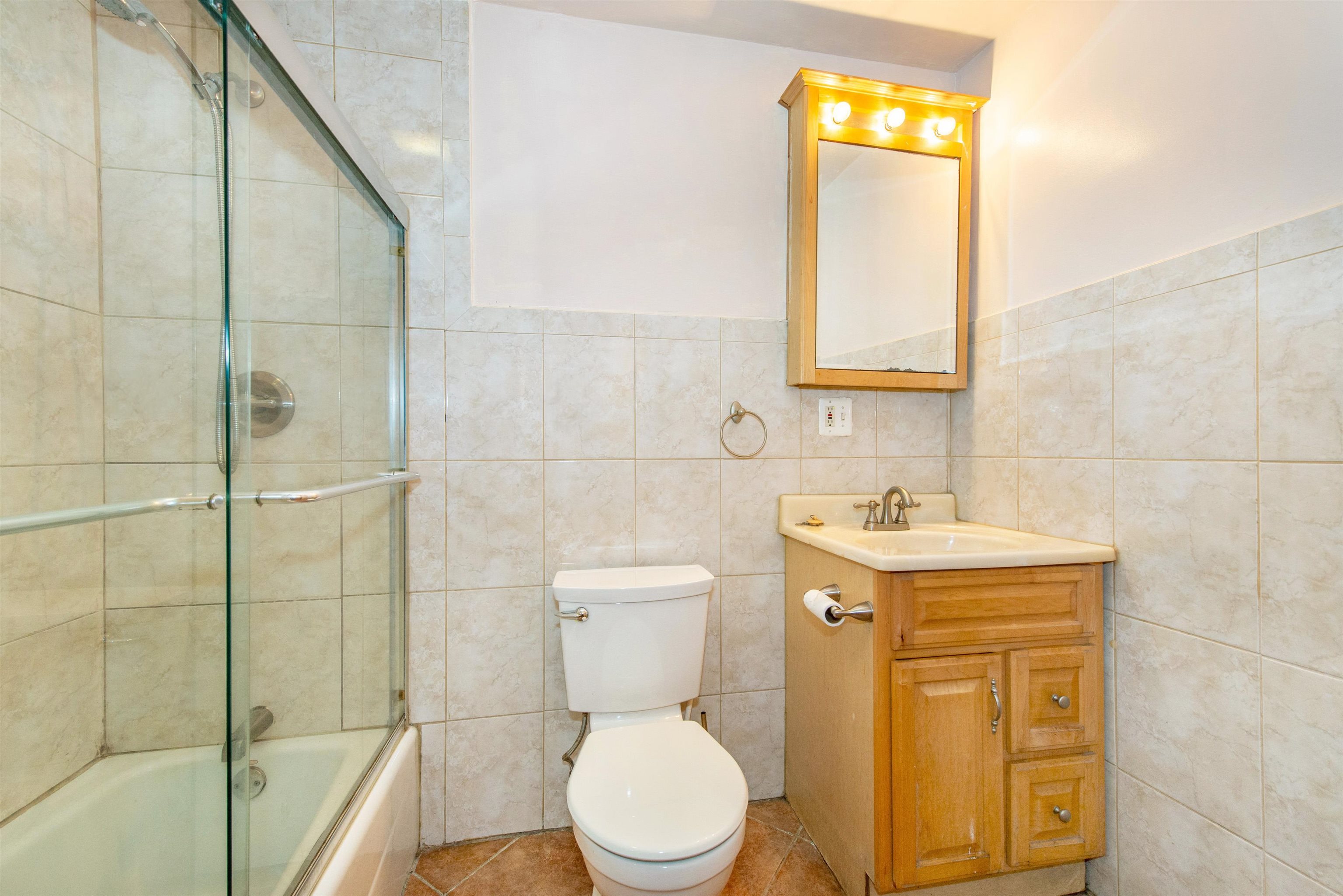 45 Monitor Street, Unit 1 Jersey City, NJ 07304 - Photo 13 of 14 a bathroom with a sink a toilet and shower