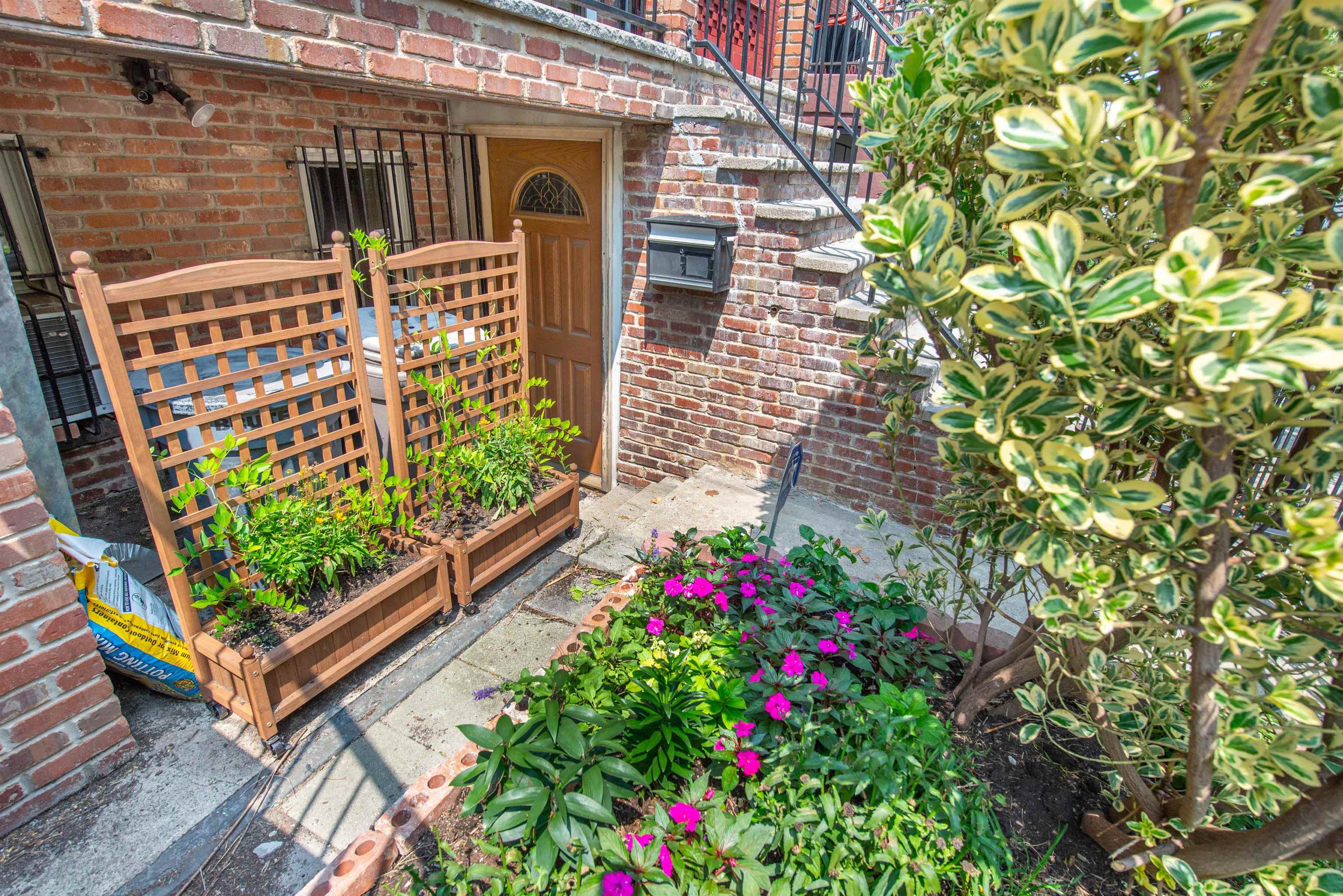 45 Monitor Street, Unit 1 Jersey City, NJ 07304 - Photo 2 of 14 a view of a wooden bench sitting in front of a building